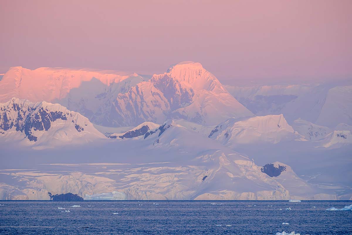pink-sunset-glow-on-snowy-mountains