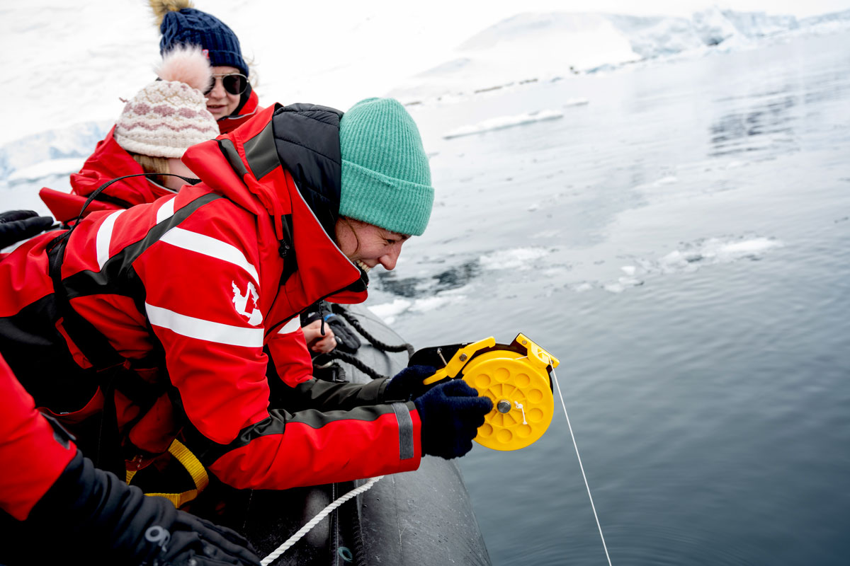 Woman in yellow bikini does the polar plunge in Antarctica
