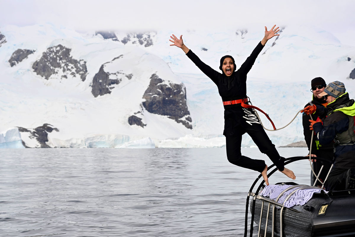 Woman in yellow bikini does the polar plunge in Antarctica